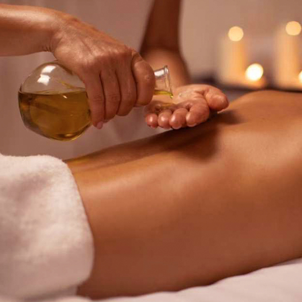 The girl uses massage oil on her hands