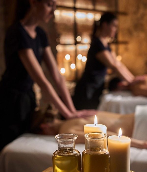 Two girls give guys a massage